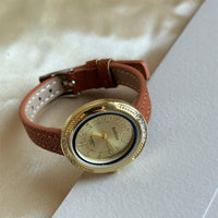 Brown with gold frame and gold face