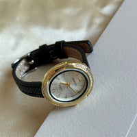 Black with gold frame and white face