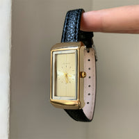 Black with gold frame and gold face