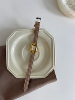 Gray belt with gold frame and gold surface