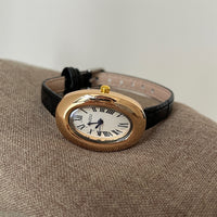 Black with gold frame and white face