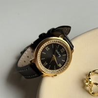 Black with gold frame and black face
