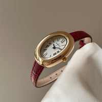 Red belt with gold frame and white face