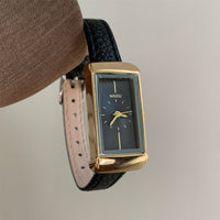 Black with gold frame and black face