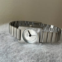 Silver belt white surface