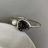 Silver band black face