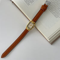Brown with gold frame and gold face
