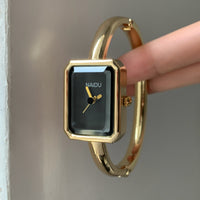 Gold band black face
