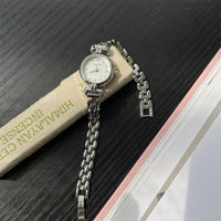 Silver belt white surface