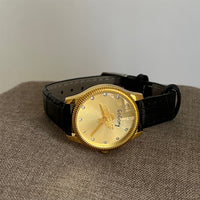Black with gold frame and gold face